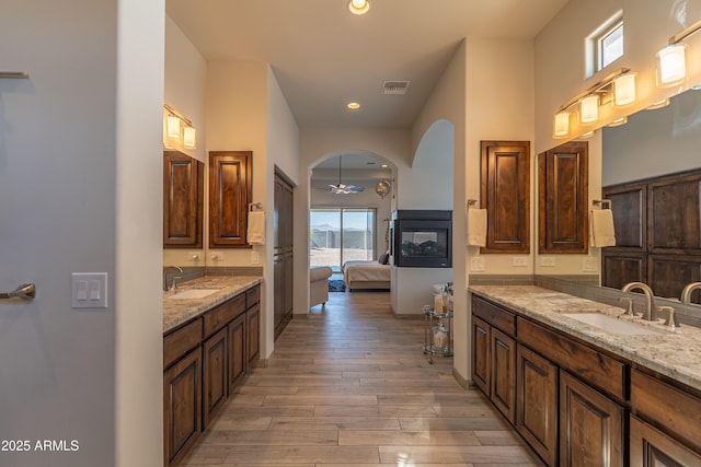14332 E Bobwhite Way, Scottsdale, AZ 85262 - ensuite bathroom featuring two vanities, wood finished floors, recessed lighting, and a ceiling fan