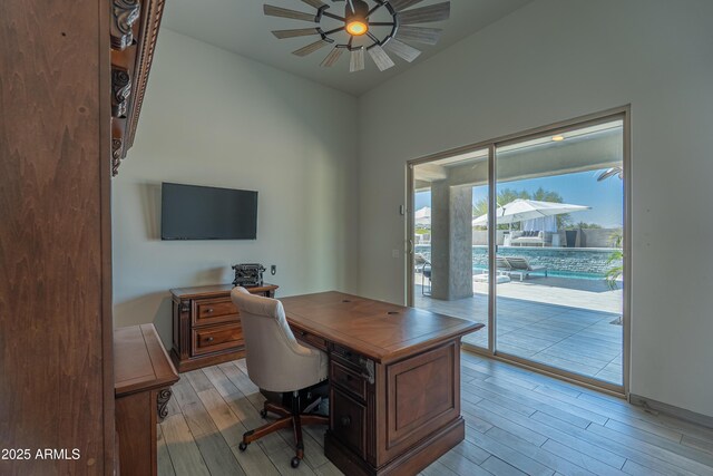 14332 E Bobwhite Way, Scottsdale, AZ 85262 - home office with a ceiling fan and light wood-style flooring