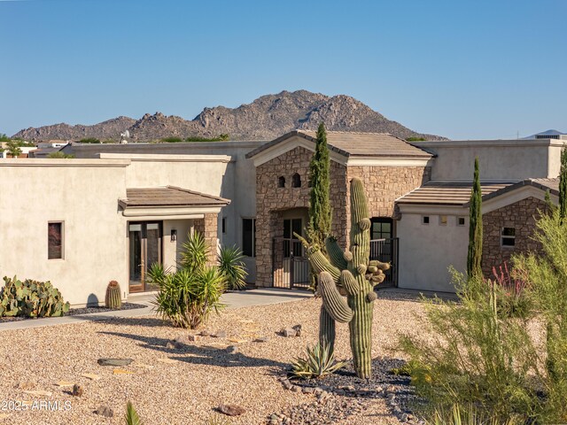 14332 E Bobwhite Way, Scottsdale, AZ 85262 - view of front of home with stone siding, a mountain view, and stucco siding
