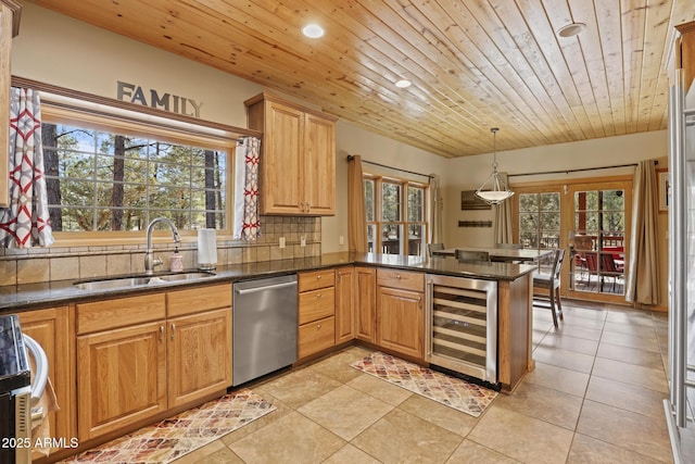 kitchen with sink, dishwasher, wine cooler, decorative light fixtures, and kitchen peninsula