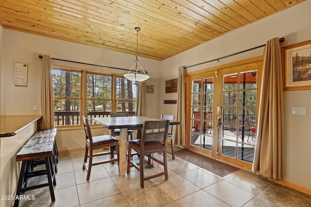 dining space with french doors, wood ceiling, and light tile patterned floors