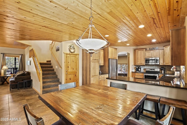 dining area featuring wood ceiling, sink, and dark tile patterned floors