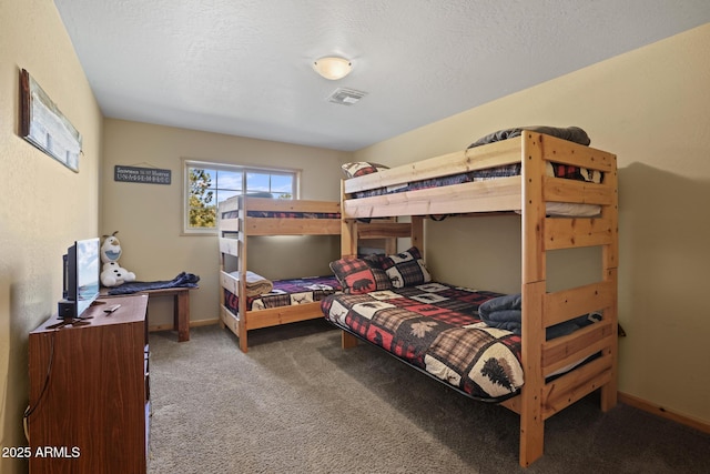 bedroom with carpet floors and a textured ceiling