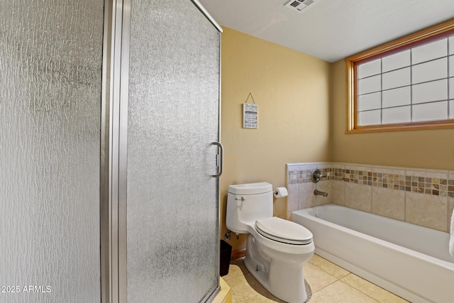 bathroom featuring tile patterned flooring, shower with separate bathtub, and toilet