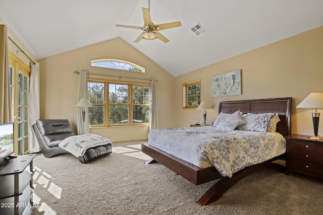 carpeted bedroom with ceiling fan and vaulted ceiling