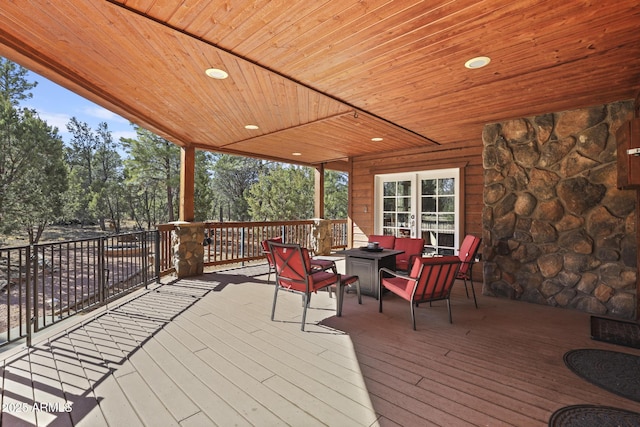 deck with an outdoor living space with a fire pit