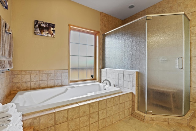 bathroom with tile patterned flooring and separate shower and tub