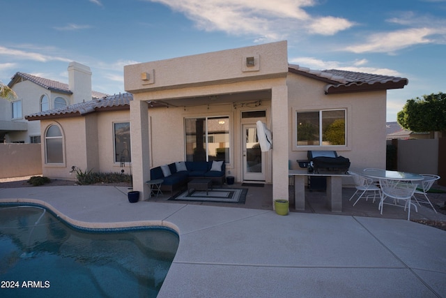 back of house with outdoor lounge area and a patio area