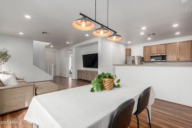 dining room with stairs, dark wood-style flooring, visible vents, and recessed lighting