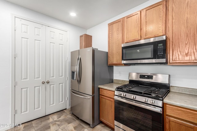 kitchen with light countertops and appliances with stainless steel finishes