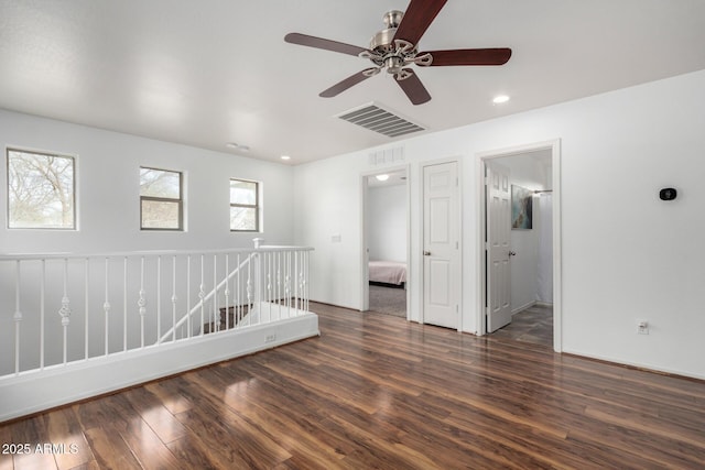 unfurnished room with wood finished floors, visible vents, and recessed lighting