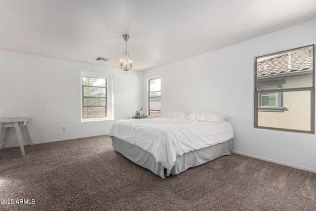 bedroom with baseboards, carpet flooring, visible vents, and an inviting chandelier