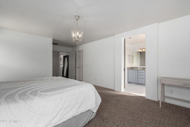 carpeted bedroom featuring a chandelier, a sink, and ensuite bath