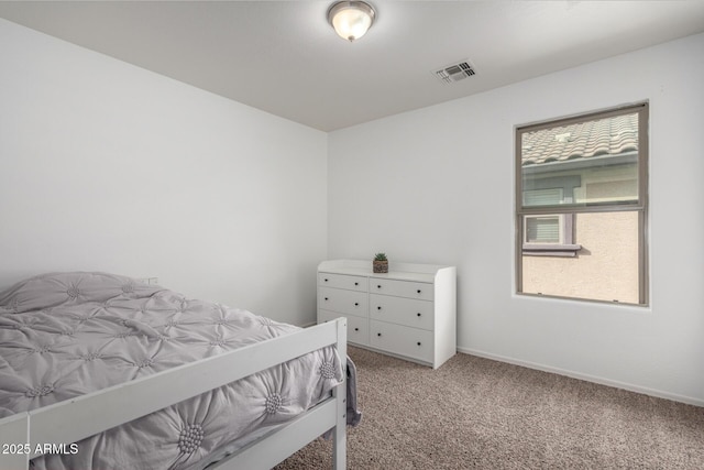 bedroom featuring baseboards, visible vents, and light colored carpet