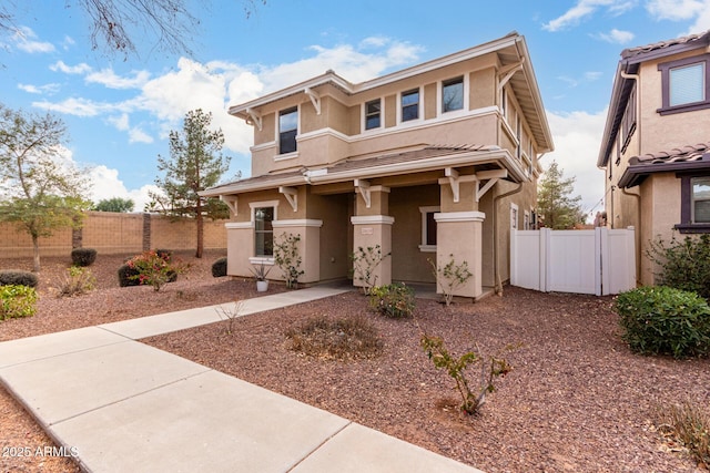 view of front of property with fence and stucco siding