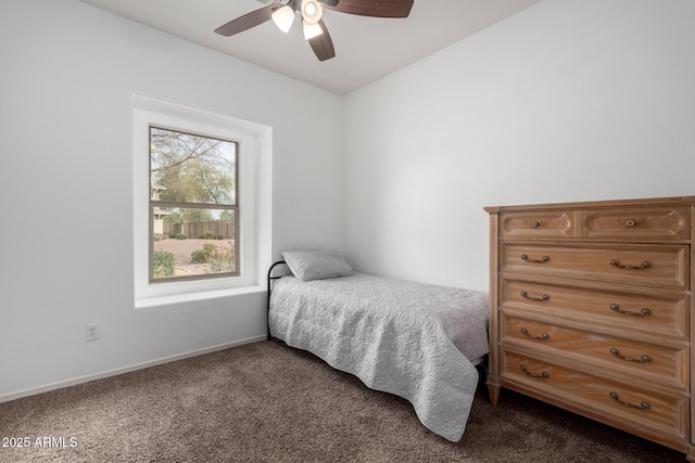 bedroom featuring ceiling fan, dark colored carpet, and baseboards