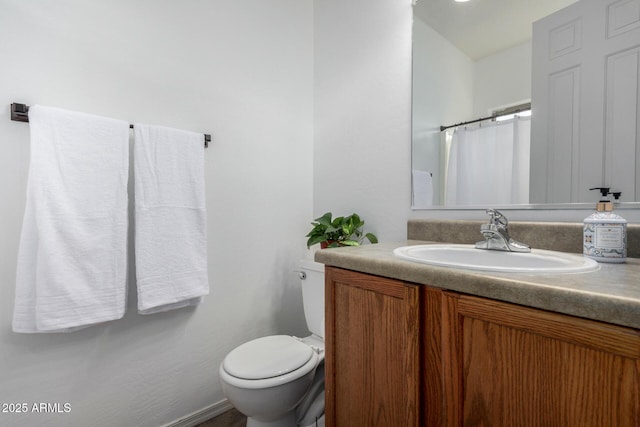 bathroom with toilet and vanity