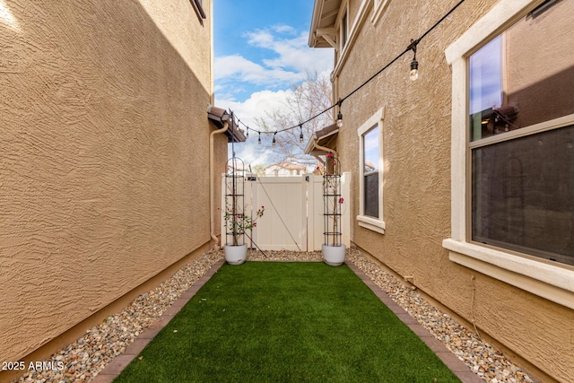 view of yard featuring fence and a gate