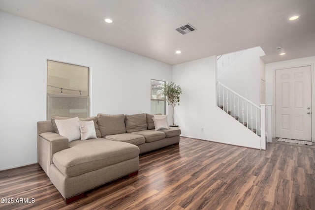 living room with recessed lighting, wood finished floors, visible vents, and stairs