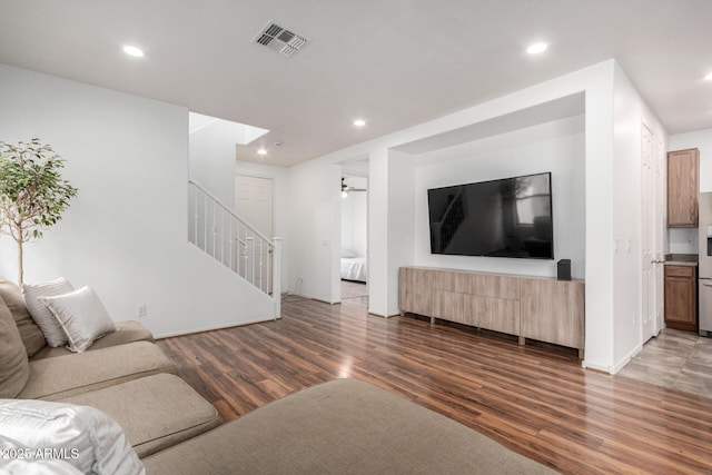 living room featuring stairway, wood finished floors, visible vents, and recessed lighting