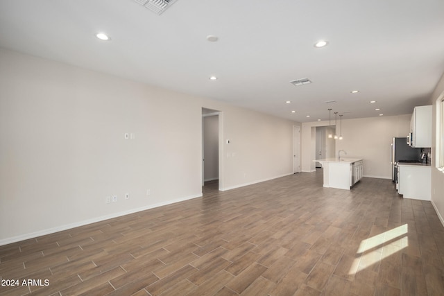 unfurnished living room with sink