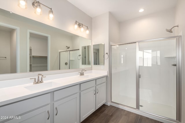 bathroom with vanity and a shower with shower door