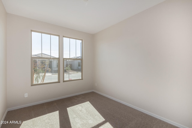 empty room featuring dark carpet