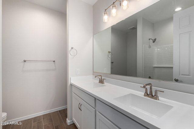 bathroom featuring vanity, toilet, and walk in shower