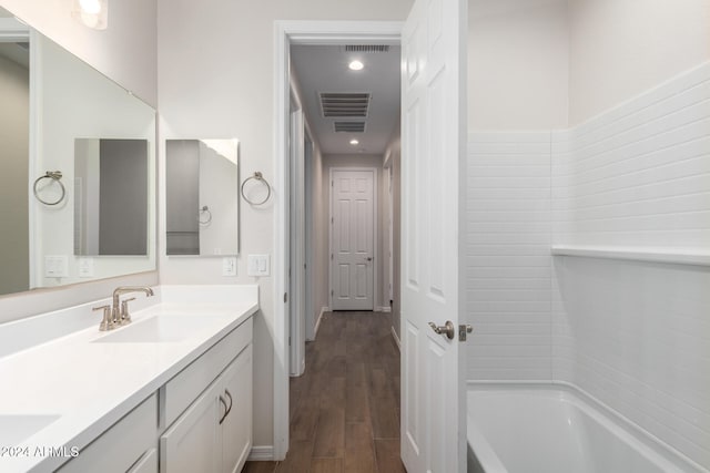 bathroom with hardwood / wood-style floors and vanity