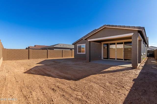 back of property with a patio