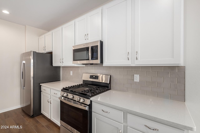 kitchen featuring tasteful backsplash, light stone counters, stainless steel appliances, dark hardwood / wood-style floors, and white cabinetry