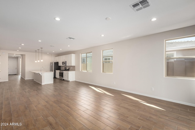 unfurnished living room with sink