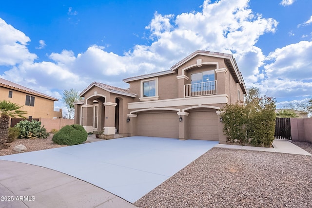 view of front of property featuring an attached garage, fence, concrete driveway, and stucco siding