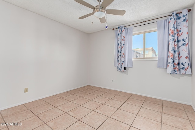 unfurnished room with light tile patterned floors, a textured ceiling, and ceiling fan