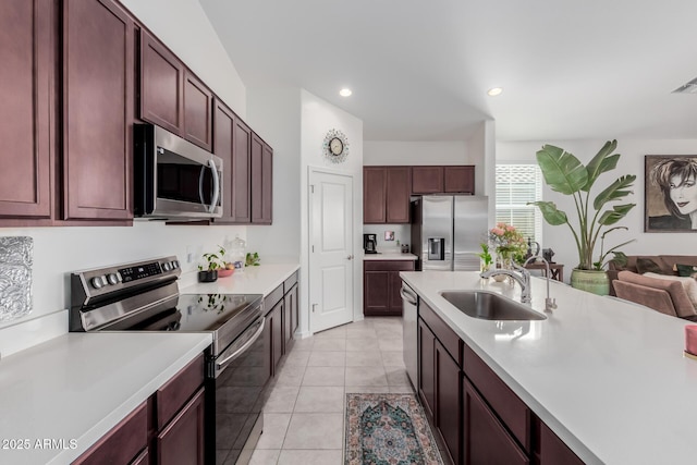kitchen with sink, light tile patterned floors, and stainless steel appliances