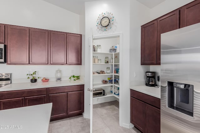 kitchen featuring stainless steel fridge and light tile patterned floors