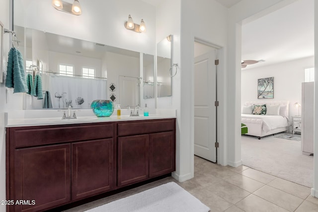 bathroom with tile patterned floors, vanity, and ceiling fan
