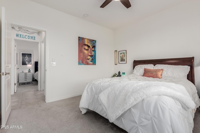bedroom with ceiling fan and light colored carpet
