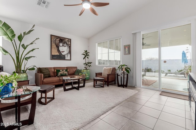 tiled living room with ceiling fan and lofted ceiling