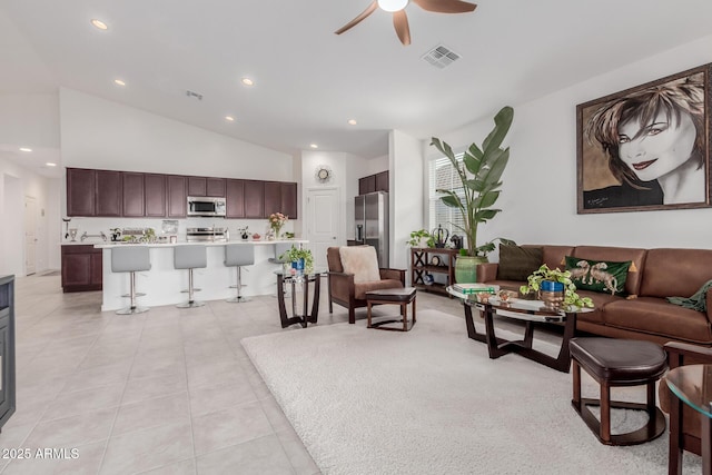 tiled living room featuring high vaulted ceiling and ceiling fan