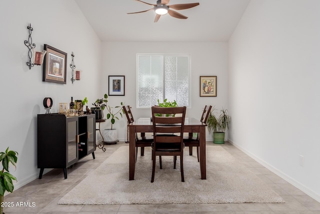 dining space with ceiling fan and light tile patterned floors