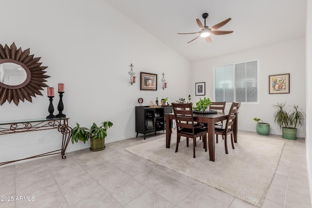 dining room with ceiling fan, light tile patterned flooring, and lofted ceiling
