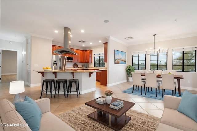 living area featuring light tile patterned flooring, a notable chandelier, recessed lighting, baseboards, and ornamental molding