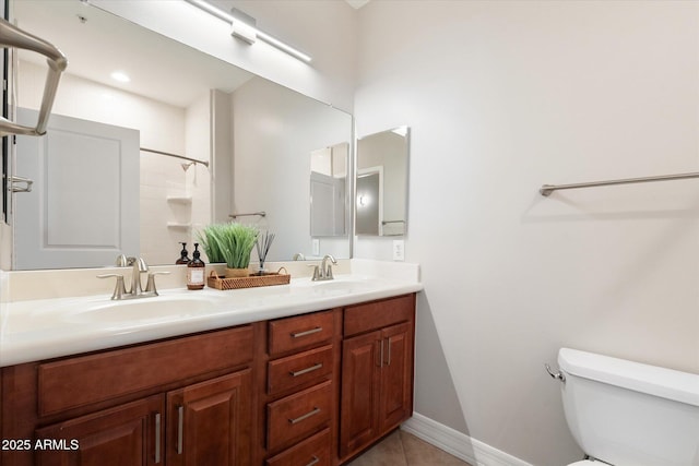 bathroom with vanity, tile patterned flooring, toilet, and walk in shower