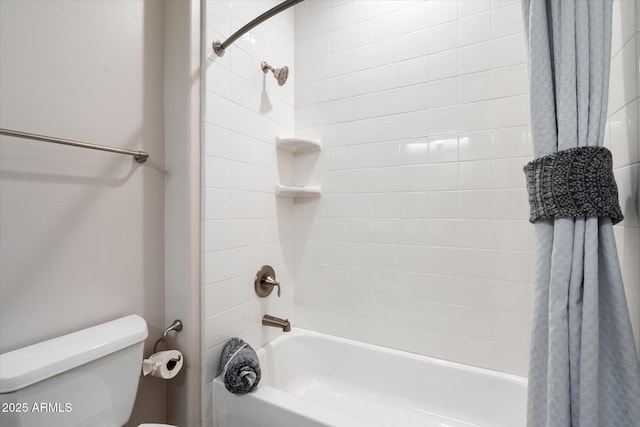 bathroom featuring shower / bathtub combination with curtain and toilet