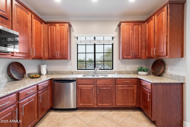 kitchen with appliances with stainless steel finishes, sink, ornamental molding, light tile patterned floors, and light stone countertops