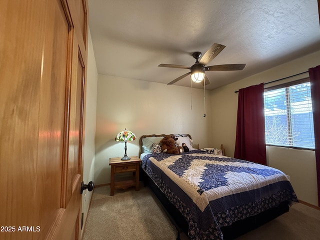 bedroom with light carpet, ceiling fan, a textured ceiling, and baseboards