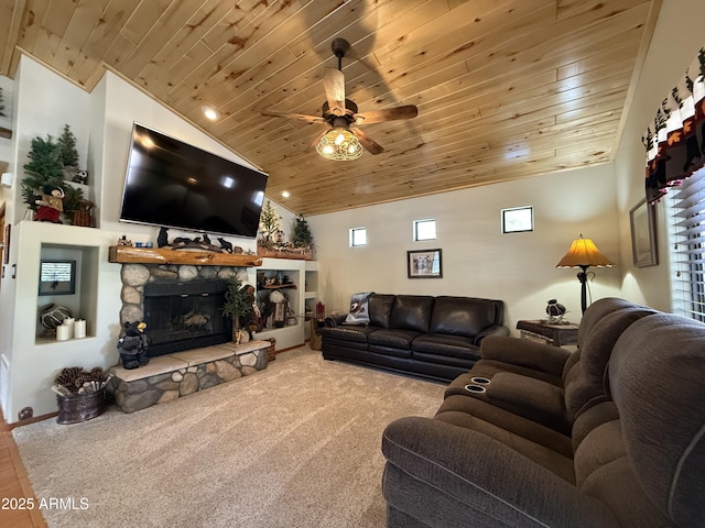 living area with ceiling fan, a stone fireplace, wooden ceiling, carpet flooring, and vaulted ceiling