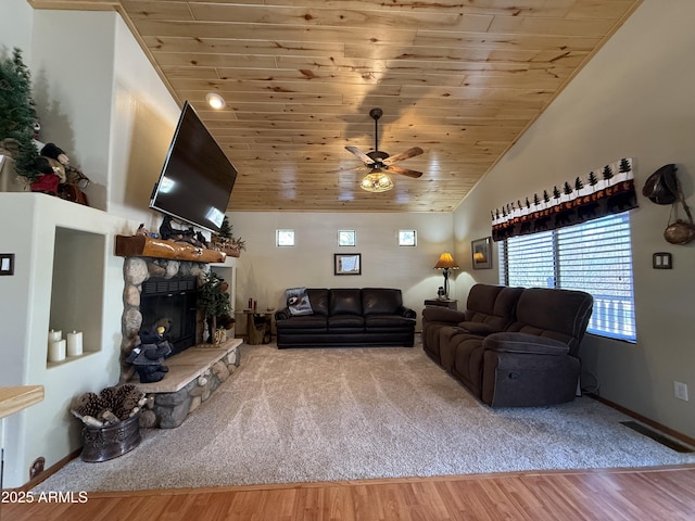 living room featuring wood ceiling, a fireplace, wood finished floors, and visible vents