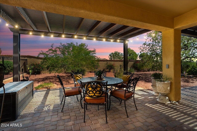 patio terrace at dusk with a pergola